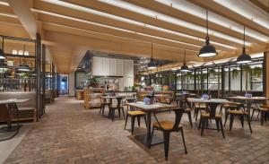 a restaurant with tables and chairs and a kitchen at Hyatt Regency Hengqin in Zhuhai