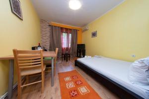a bedroom with a bed and a table and a dining room at Apartment Kalemegdan in Belgrade