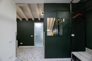 a hallway with green walls and a door with a mirror at Oysters & Bubbles Gastro Hotel. Rynok square in Lviv +175 photos