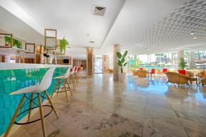 a lobby with a bar with chairs and tables at Bull Eugenia Victoria & SPA in Playa del Ingles