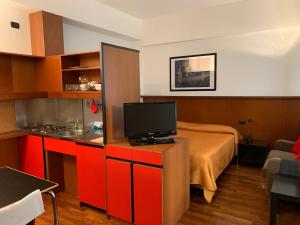 a room with a bed and a television on a cabinet at Residence Le Corti in Milan