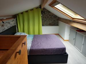 a bedroom with a bed and a green curtain at Duplex Swimming Cats in Saint-Hilaire-sur-Helpe +32 photos