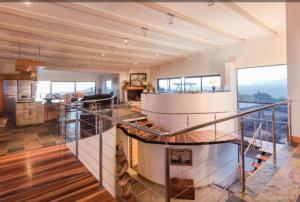 a large room with a staircase in a building at Lighthouse in Brenton-on-Sea