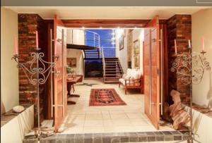 a hallway with an open door to a living room at Lighthouse in Brenton-on-Sea