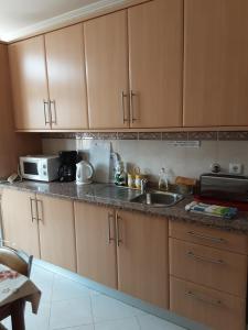 a kitchen with a sink and a microwave at SOL & MAR in Lagos