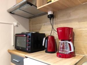 a kitchen counter with a microwave and a coffee maker at Lemon Tree Inn in Markopoulo