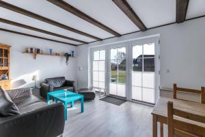 a living room with a couch and a table at Ferienwohnung Nordseeperle in Friedrichskoog-Spitze