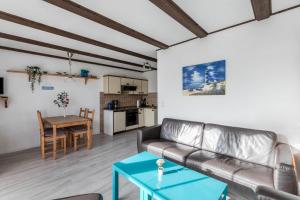 a living room with a couch and a table at Ferienwohnung Nordseeperle in Friedrichskoog-Spitz