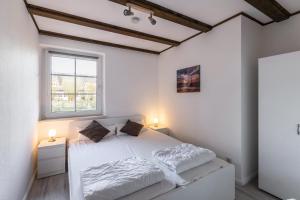 Llit o llits en una habitació de Ferienwohnung Nordseeperle
