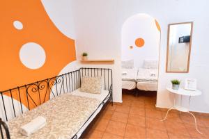 a small room with a bed and a mirror at La Casa Mata Central in Málaga +23 photos
