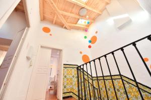 a staircase in a house with colorful tiles on the wall at La Casa Mata Central in Málaga