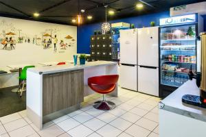 a store with a counter with a red chair in it at Capsule Hotel InterQUBE Bolshaya Polyanka in Moscow