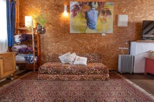 a living room with a couch and a painting on the wall at Healing Hands in Merom Golan