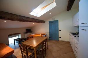 a kitchen with a wooden table and a dining room at Agriturismo Arte Contadina in Fiorenzuola dʼArda +15 photos