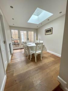 a dining room with a table and chairs and a skylight at The Old Carriage House in York