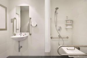 a bathroom with a sink, toilet and shower stall at TRYP by Wyndham Dubai in Dubai