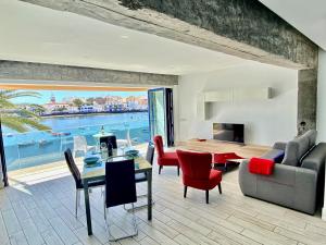 a living room filled with furniture and a large window at Charco Loft Panoramic Mirador ADULT ONLY in Arrecife