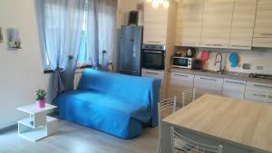 a kitchen with a blue couch and a table at Miriamare in Albissola Marina
