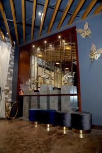 a room with a counter with butterflies on the wall at DD Suites Hotel in Agra