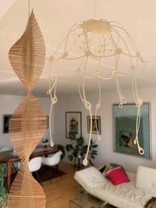 a chandelier hanging from the ceiling in a living room at ApartmentInCopenhagen Apartment 651 in Copenhagen