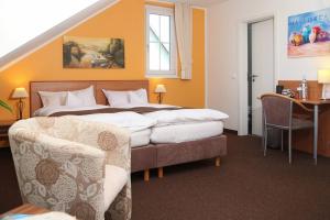 a hotel room with two beds and a table and chairs at Hotel Fürstenberg in Essen +10 photos