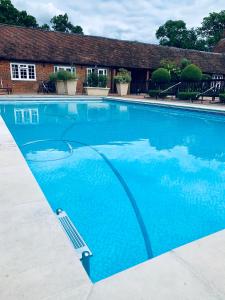 a large blue swimming pool with a paddle in it at Luxury Cottage & Spa in Guildford