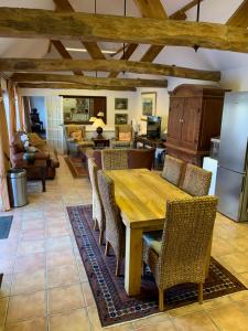 a kitchen and living room with a wooden table and chairs at Luxury Cottage & Spa in Guildford
