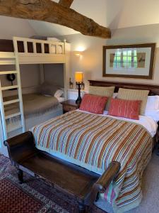 a bedroom with a bed and two bunk beds at Luxury Cottage & Spa in Guildford +15 photos