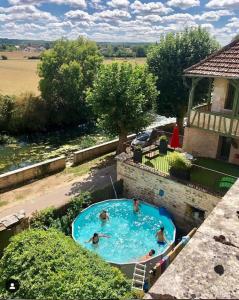 a group of people swimming in a swimming pool at Côté-Serein - Domaine de Venoise in Noyers
