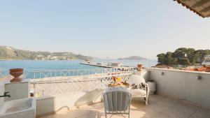 a balcony with chairs and a view of the water at Casa Blue Sea View, Philian Collection in Skiathos Town