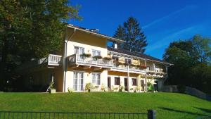 a large house with a balcony on a hill at Parkhotel Ruhpolding in Ruhpolding