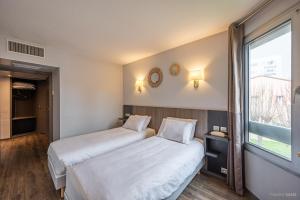 Кровать или кровати в номере Hotel Gascogne