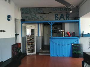 a bar with a blue counter in a room at Przystanek Smerek in Wetlina