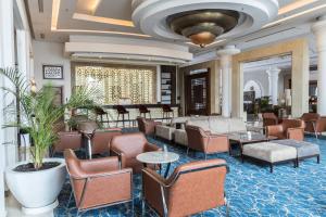 a lobby of a hotel with chairs and tables at Savoy Le Grand Hotel Marrakech in Marrakech