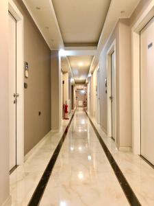 a hallway in a building with a long corridor at Hotel Folen in Milan