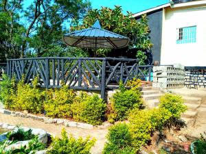 a umbrella sitting on top of a wooden bridge at Vienna Woods Hotel Nakuru in Nakuru