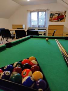 a billiard room with a pool table and balls at Holiday Home in Quiet Beautiful Area With Two Separate, Modern, Furnished Apartments in Deutsch-Wagram