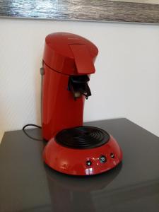利摩日的住宿－STUDIO cosy dans le centre de LIMOGES，一张桌子上的一个红色咖啡壶