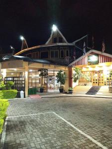 a large building at night with a cobblestone street at Vienna Woods Hotel Nakuru in Nakuru