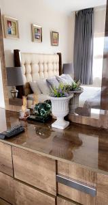 a living room with a bed and a table at Green Haven Luxury Apartments in Ezulwini