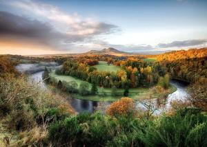 an aerial view of a river with trees and a mountain at Dryburgh Arms Pub with Rooms in Melrose