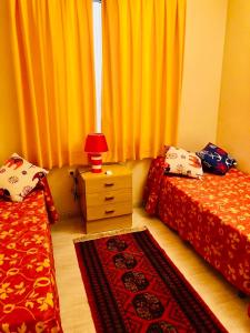 a bedroom with two beds and a lamp on a dresser at Vera Natura Urbanización Naturista in Vera