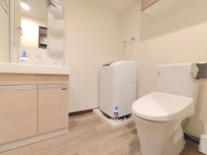 a white bathroom with a toilet and a sink at Otsuka No 4 Mansion in Tokyo +18 photos