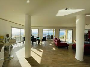 a living room with a view of the ocean at Grand appartement - Central Beach - Résidence de la Rose in Sainte-Maxime