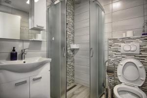 a bathroom with a toilet and a sink and a shower at Rooms DRAGICA in Pakoštane