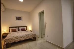 a bedroom with a bed and a door to a hallway at Rooms DRAGICA in Pakoštane