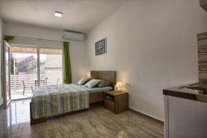 a bedroom with a bed and a large window at Rooms DRAGICA in Pakoštane