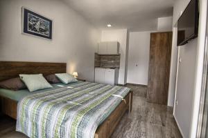 a bedroom with a large bed in a room at Rooms DRAGICA in Pakoštane