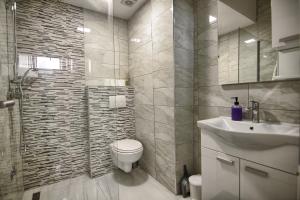 a bathroom with a toilet and a sink at Rooms DRAGICA in Pakoštane