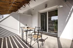 a room with a table and chairs on a balcony at Rooms DRAGICA in Pakoštane